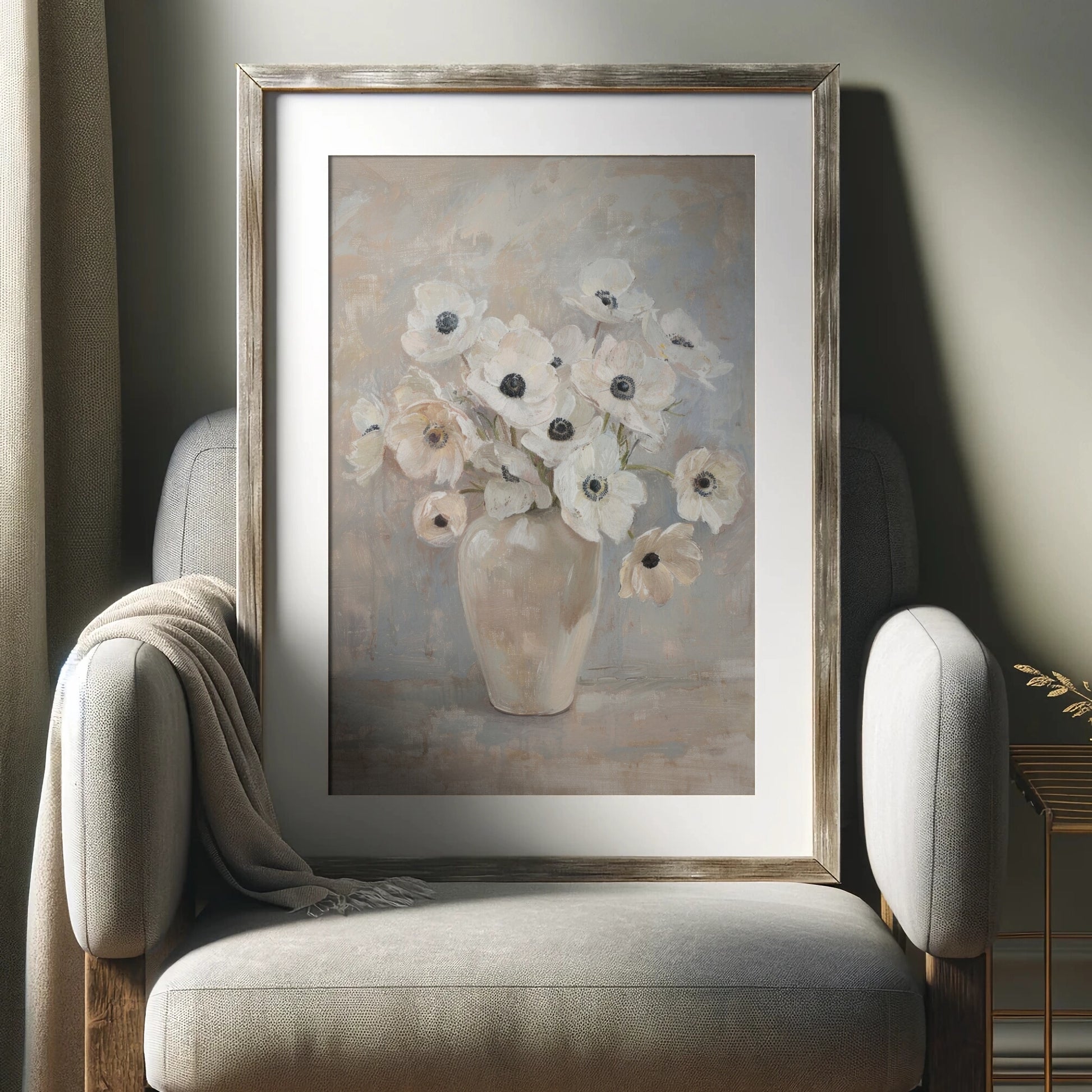 Framed painting of flowers on a wall above a chair