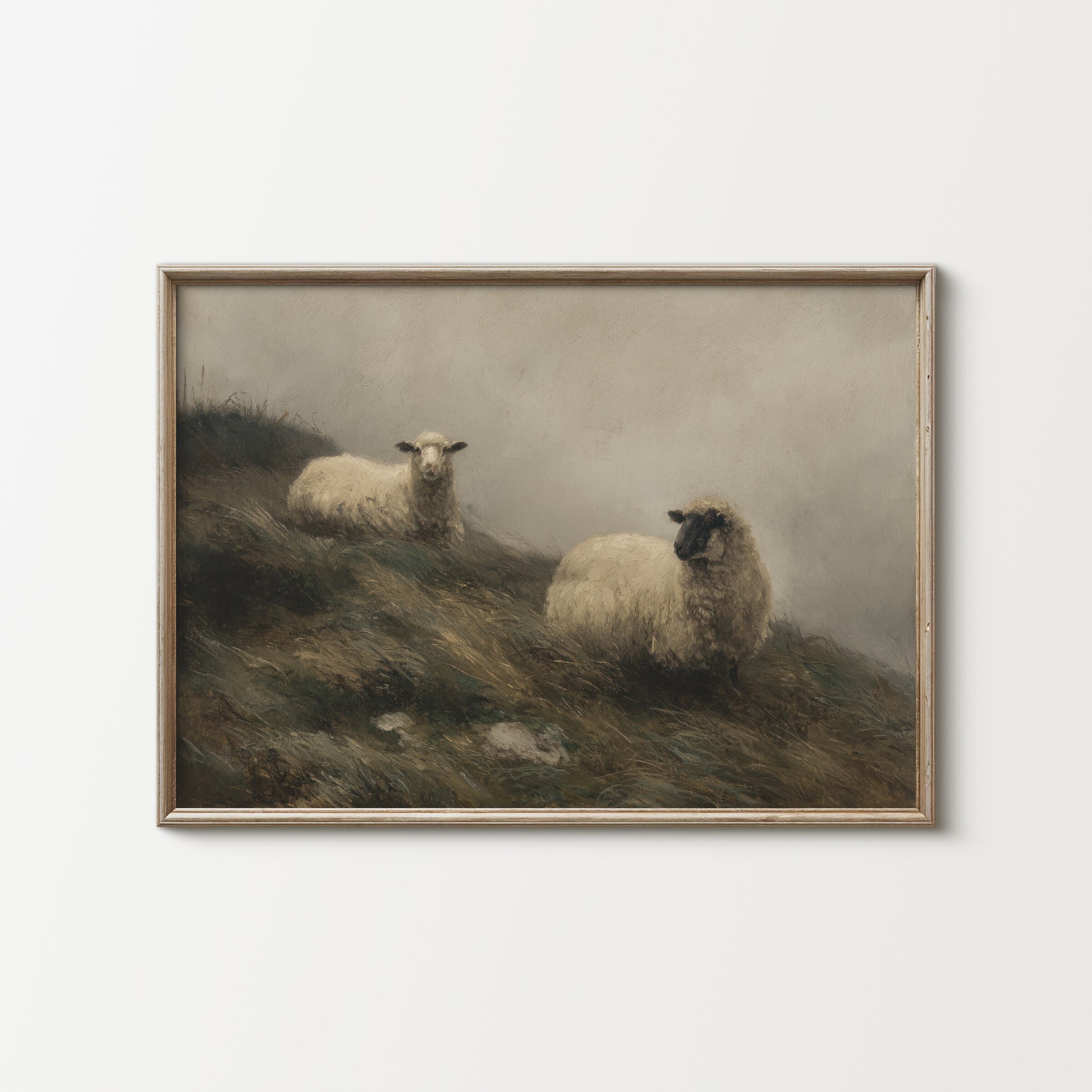 Framed painting of two sheep on a hillside with a misty background