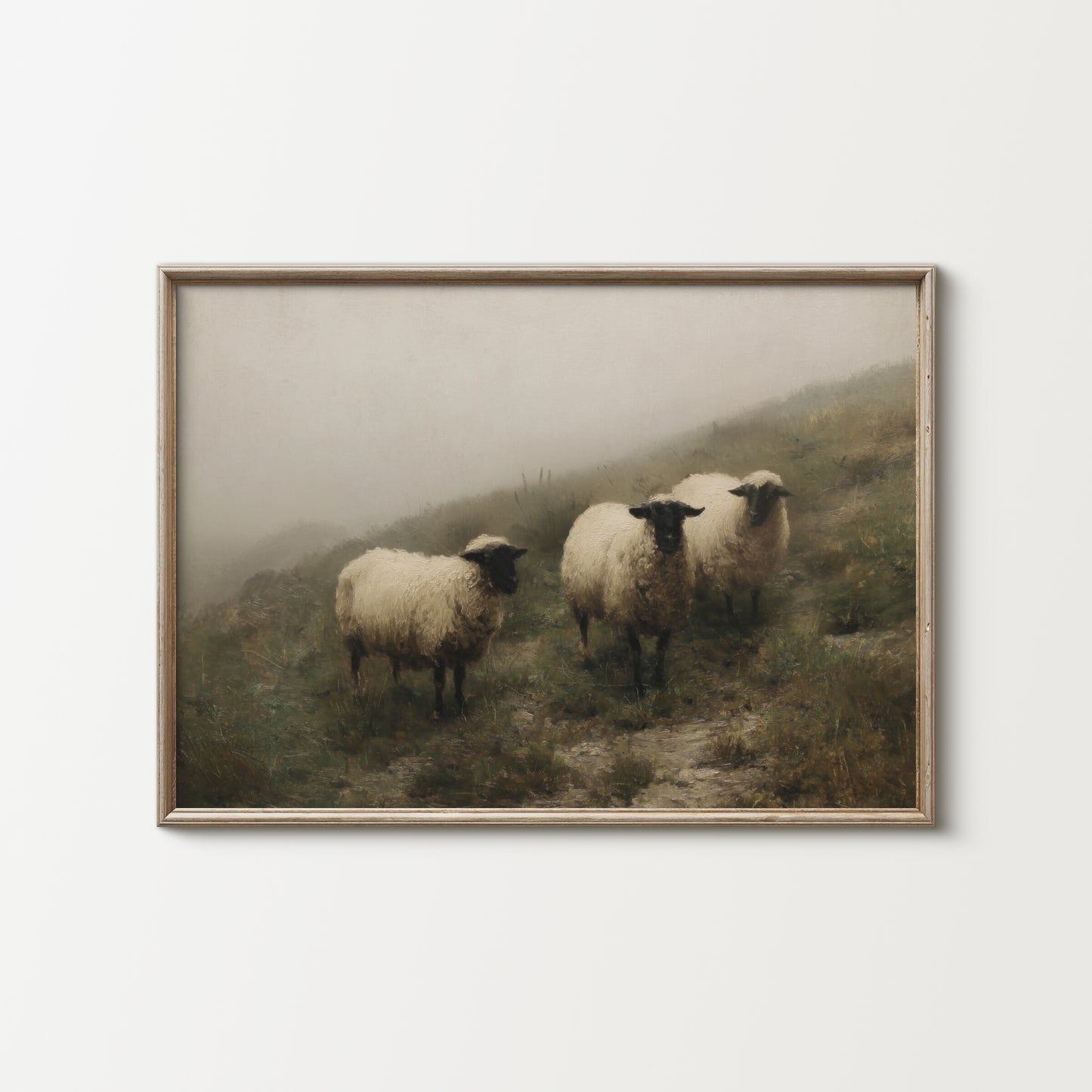 Framed artwork of three sheep on a misty hillside