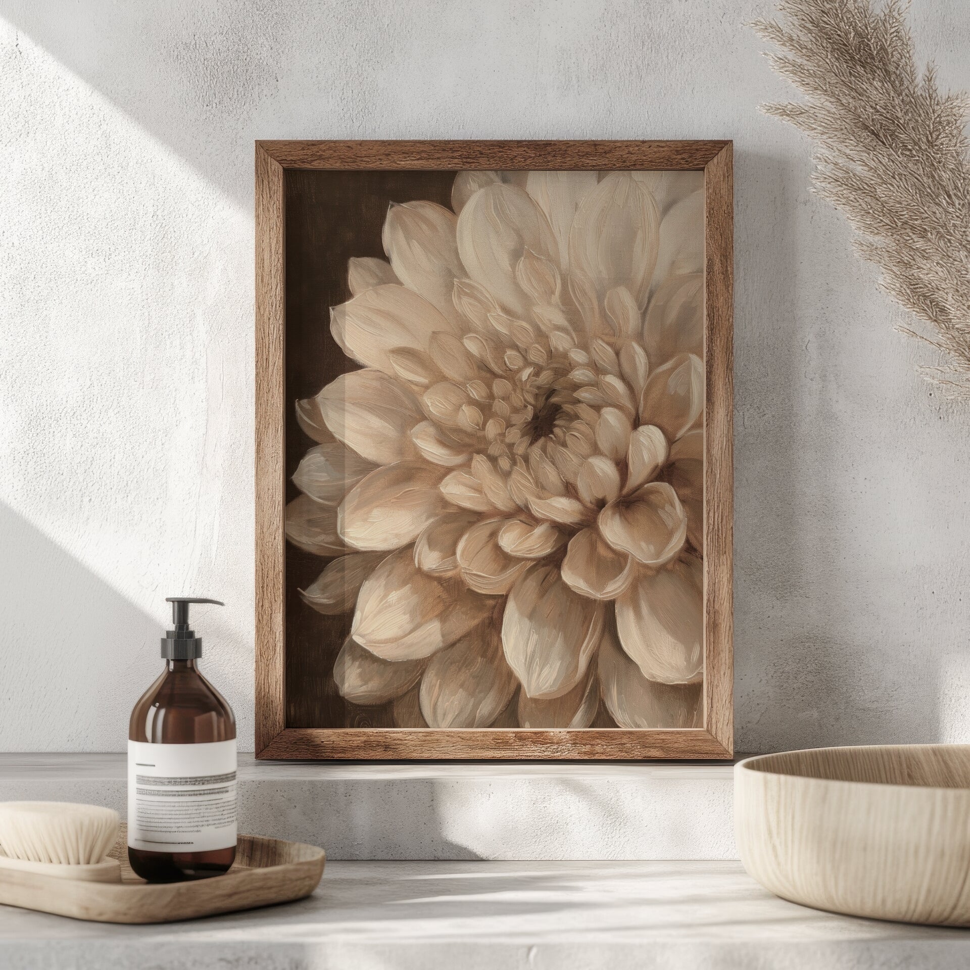 Framed floral artwork on a wall with a bottle and decorative items below.