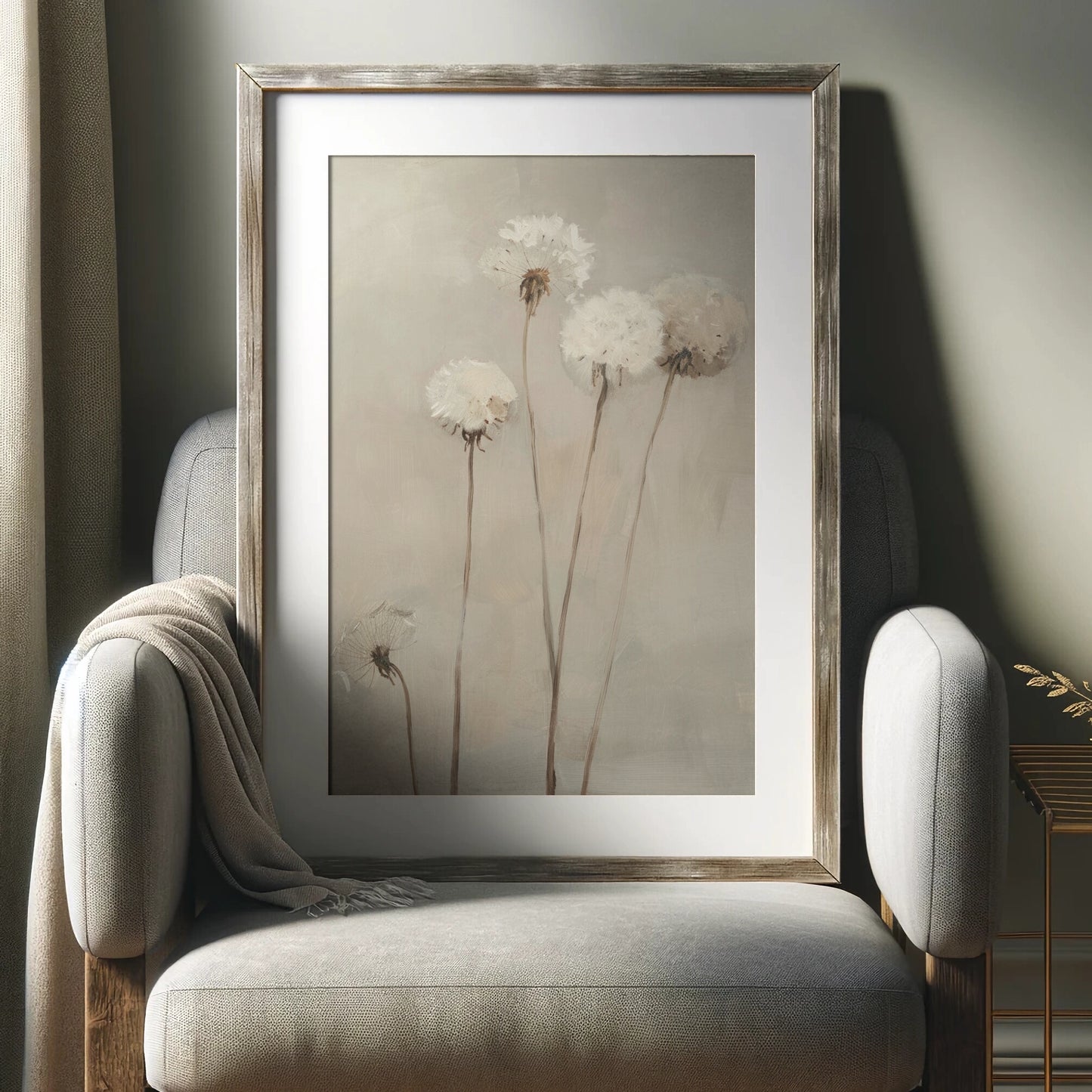 Framed artwork of dandelions on a neutral-colored armchair.