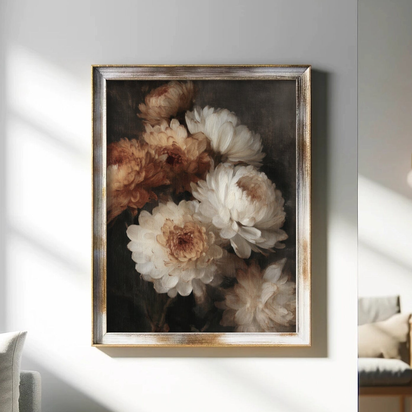 Framed floral artwork on a wall in a living room with sunlight streaming through a window.