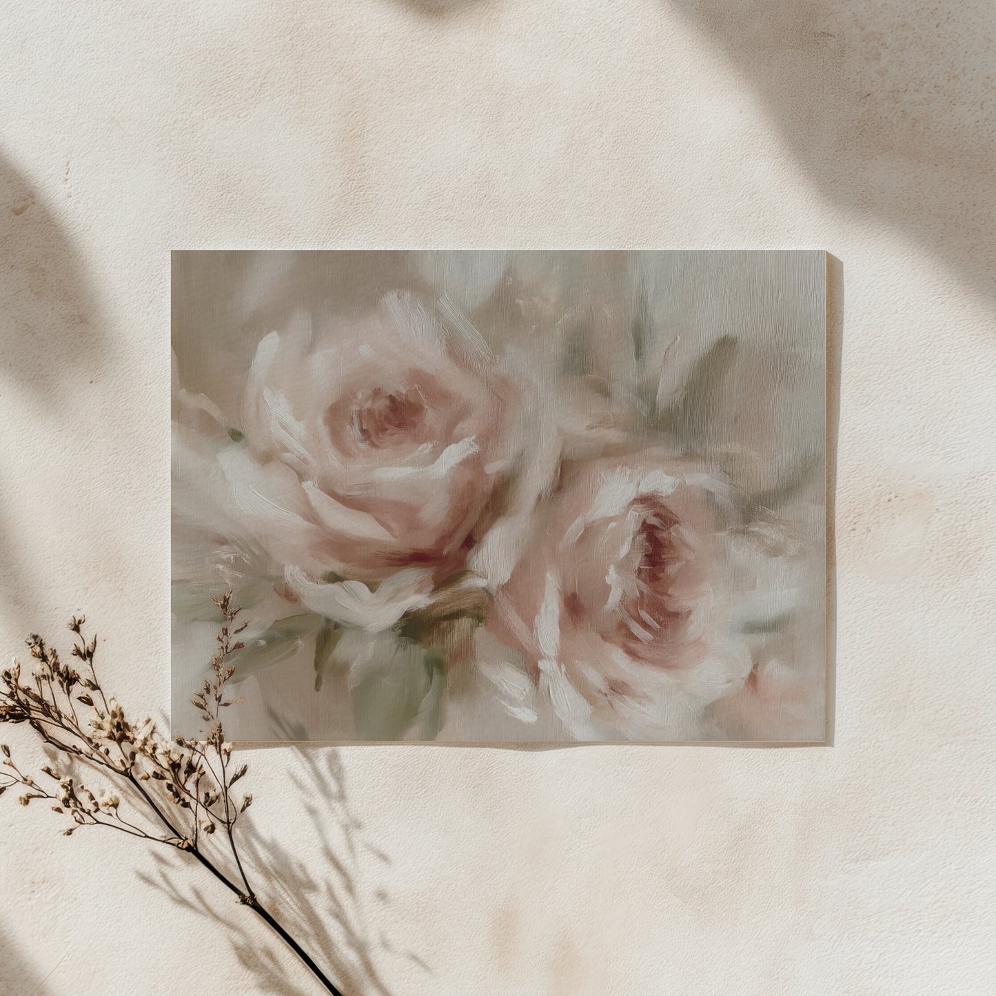 Framed artwork of pink roses on a beige wall