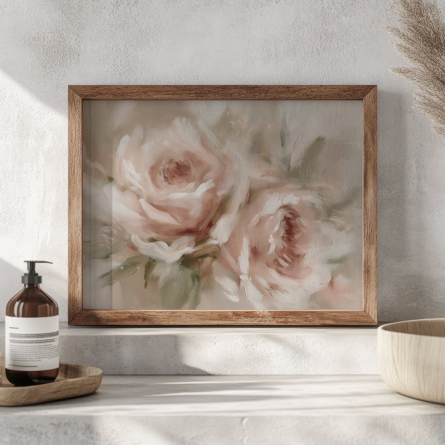 Framed floral painting on a wall with a bottle and bowl in the foreground.