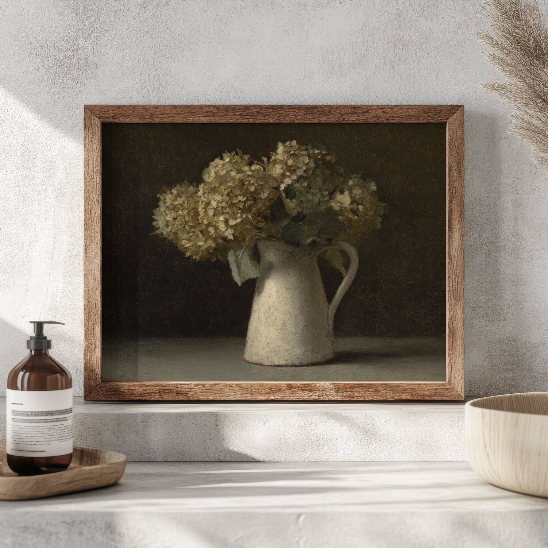 Framed artwork of a still life with flowers in a pitcher on a shelf.