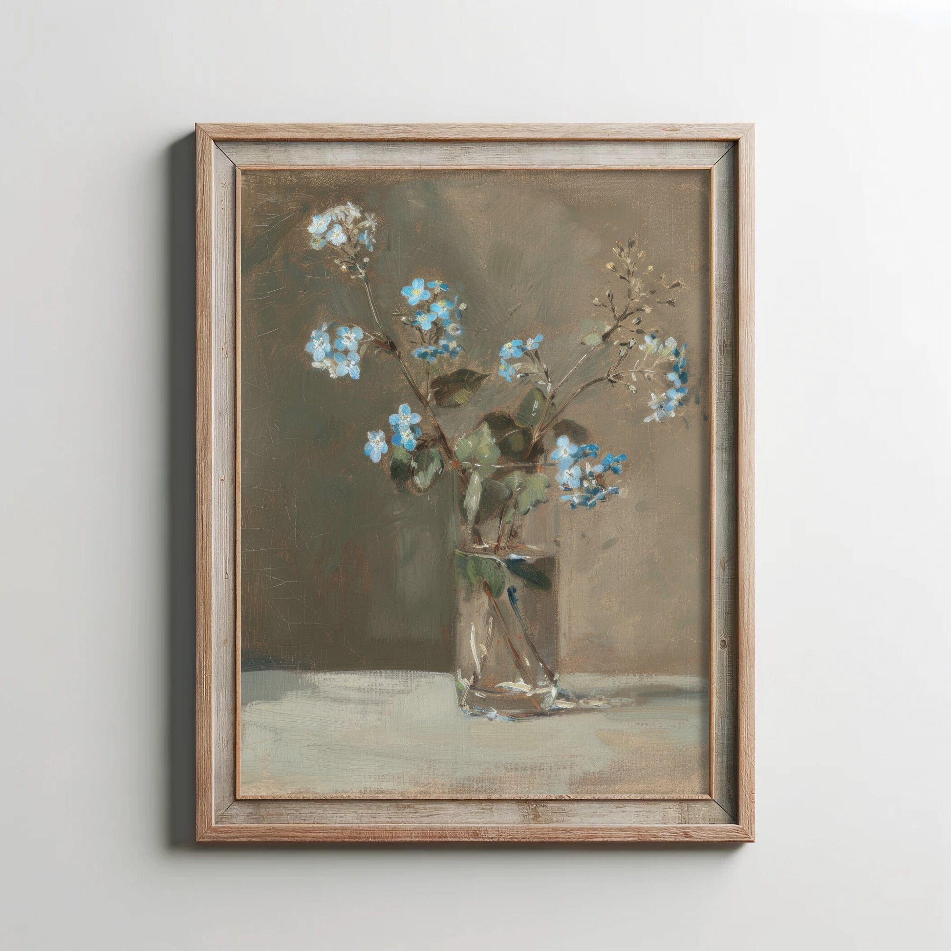 Framed painting of flowers in a glass vase on a light gray wall