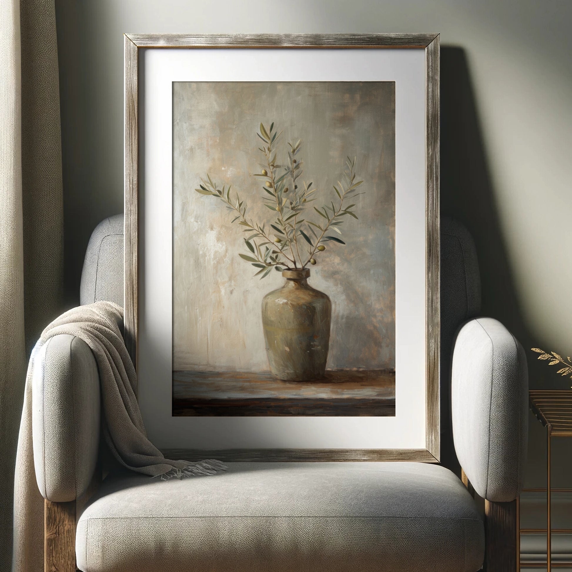 Framed painting of a vase with branches on a neutral-colored chair.