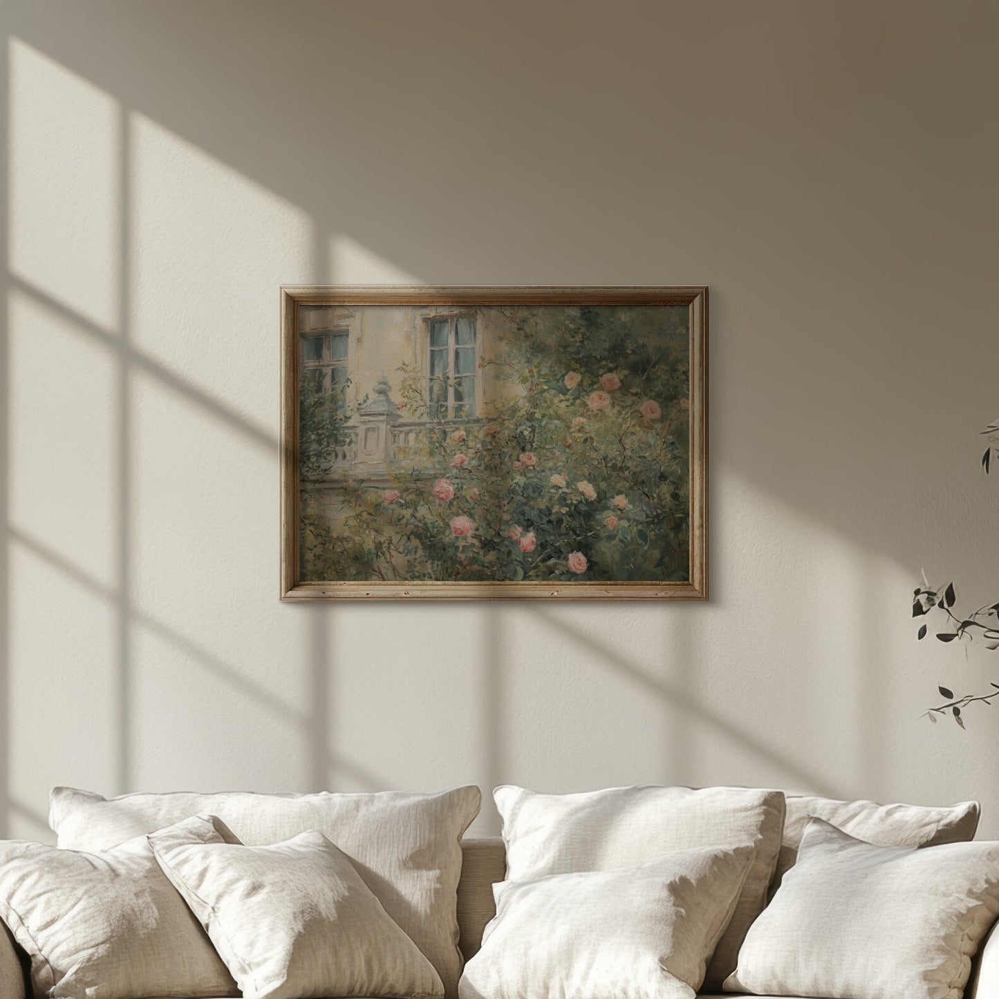 White sofa in a room with sunlight streaming through a window, casting shadows on the wall.