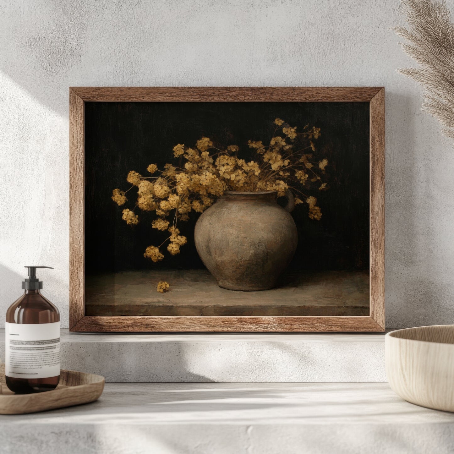 Framed artwork of a vase with yellow flowers on a shelf with a bottle and bowl.
