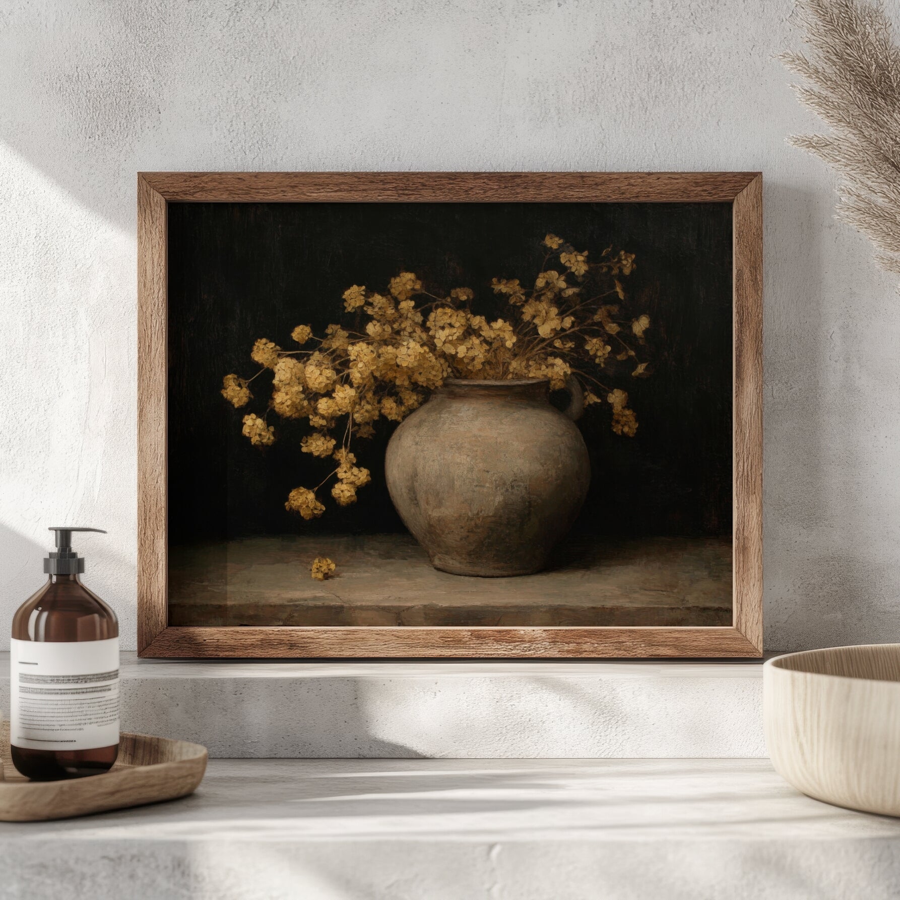 Framed artwork of a vase with yellow flowers on a shelf with a bottle and bowl.