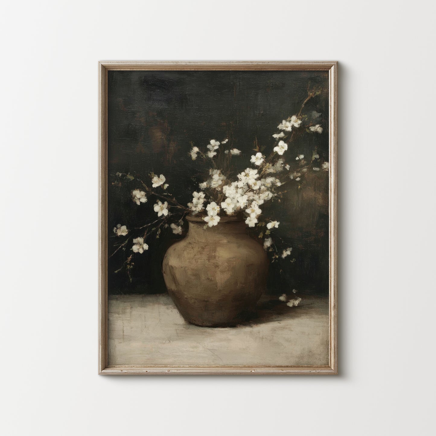 Framed artwork of a vase with white flowers on a plain background