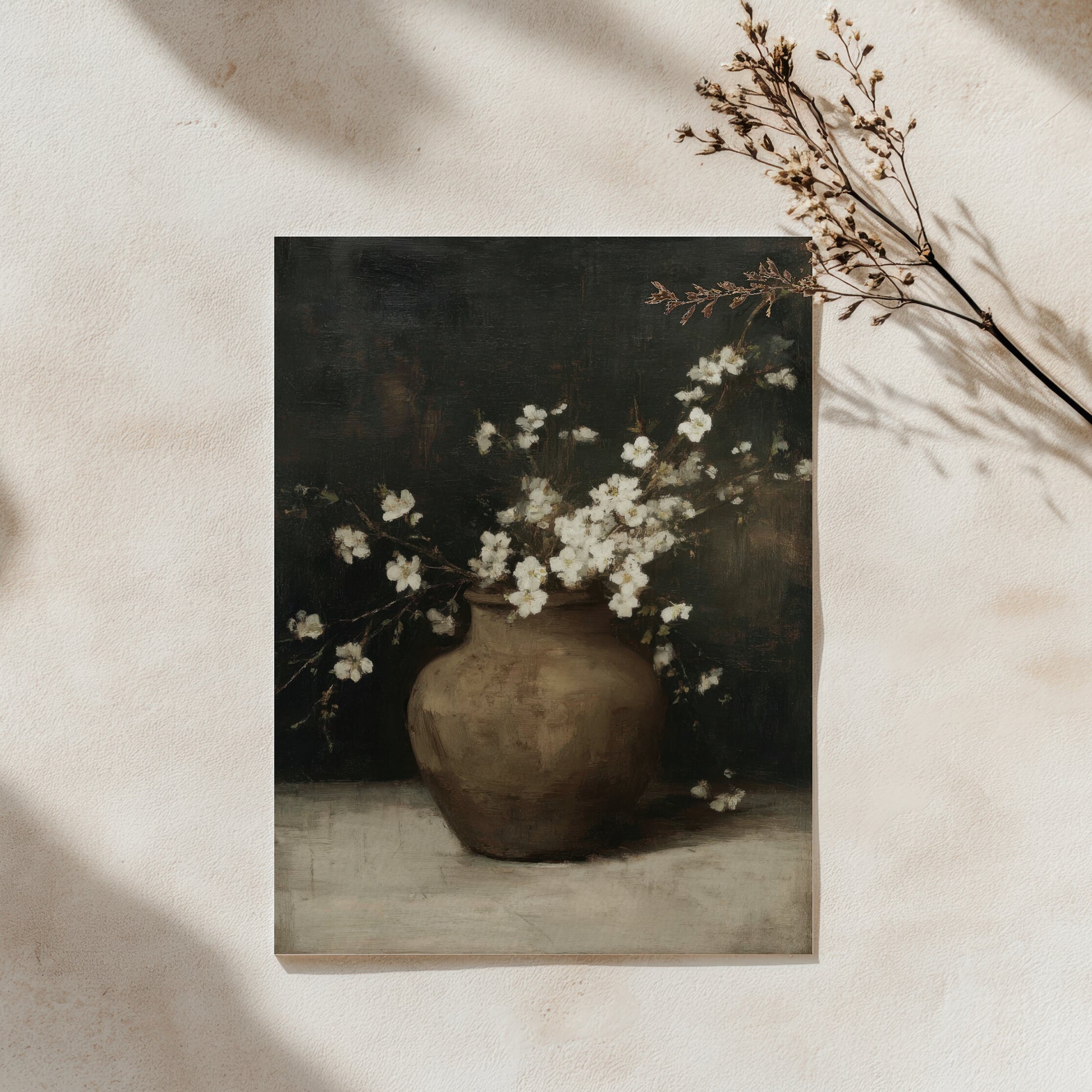 Framed artwork of a vase with white flowers on a neutral background