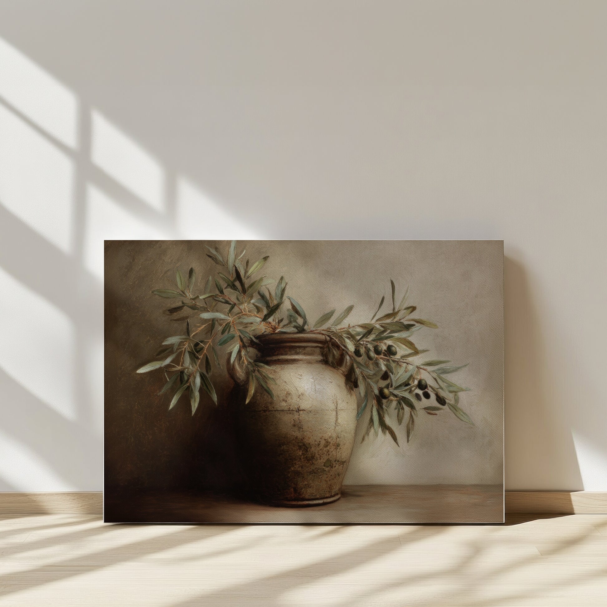 Framed artwork of a vase with greenery on a neutral background