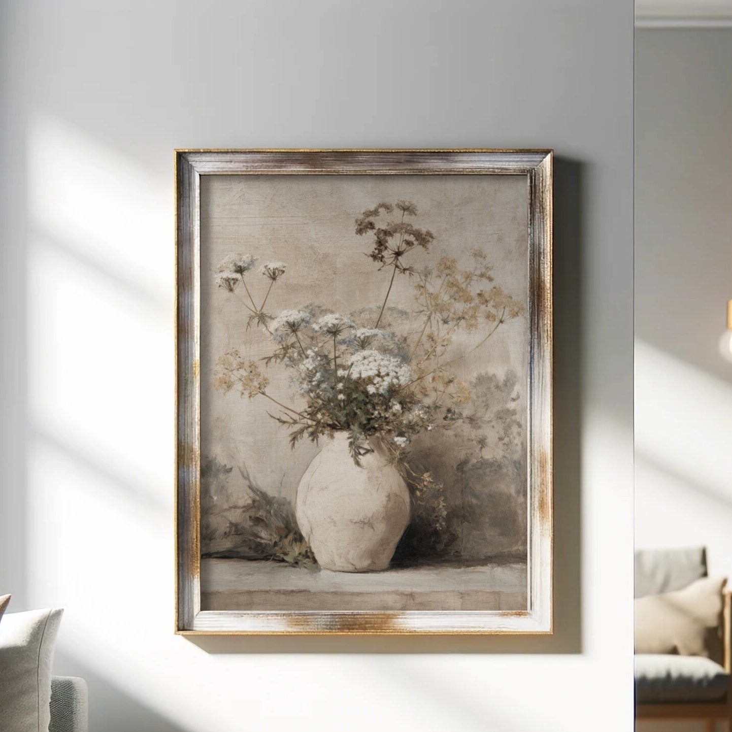Framed artwork of a vase with flowers on a wall in a living room.