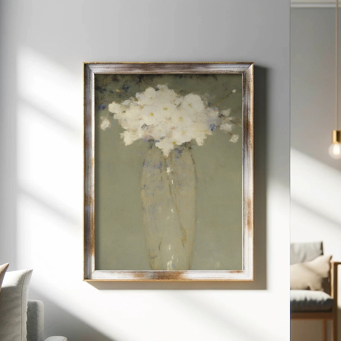Framed artwork of a vase with white flowers on a wall