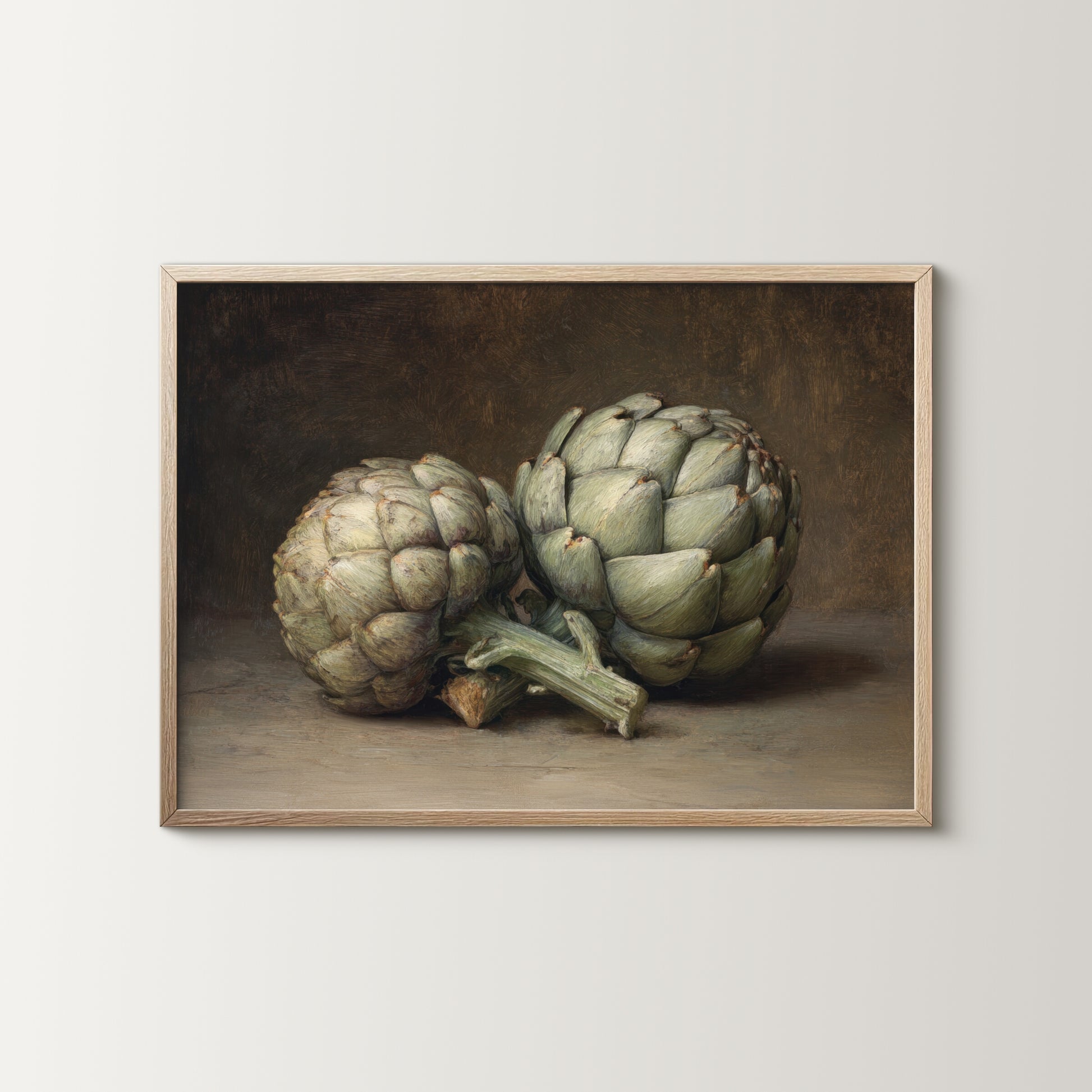 Framed artwork of two artichokes on a neutral background