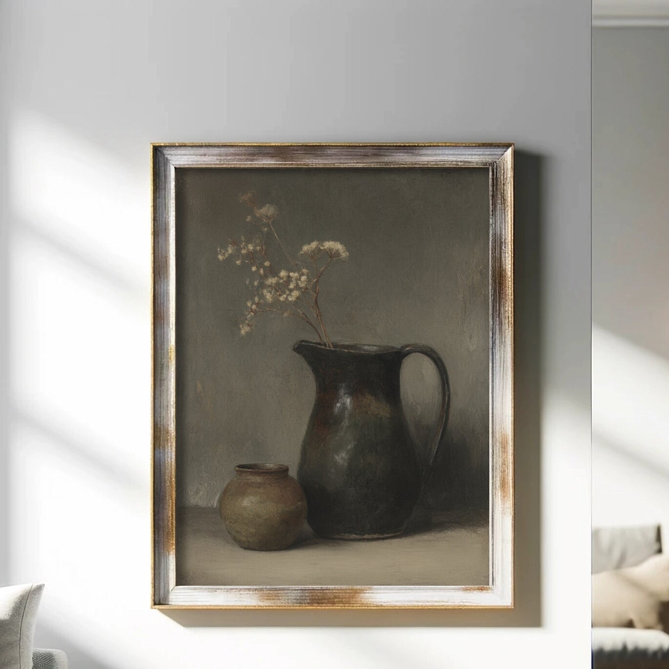 Framed still life painting on a wall in a living room with sunlight casting shadows.
