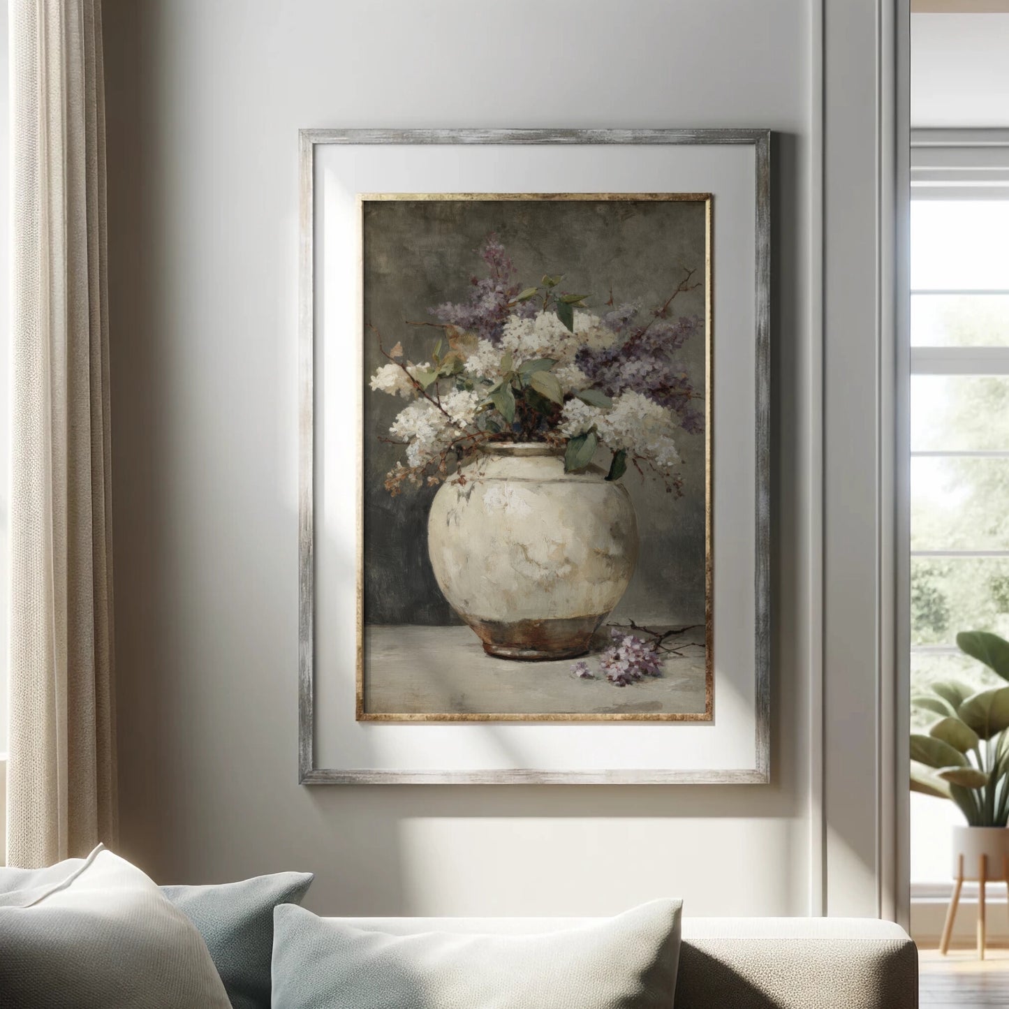Framed painting of a vase with flowers on a wall in a living room.