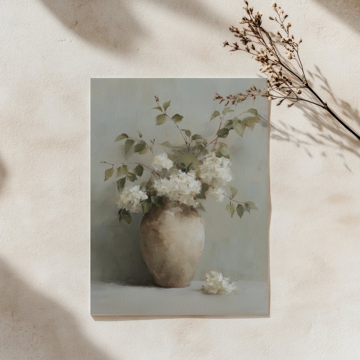 Framed artwork of a vase with white flowers on a beige background