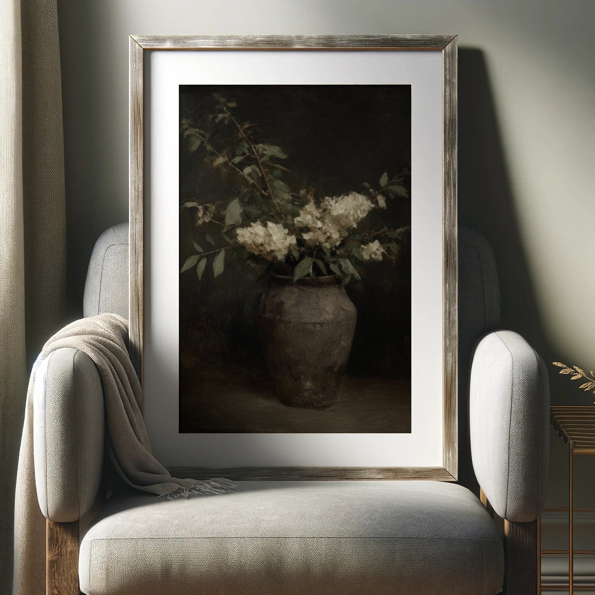 Framed artwork of a vase with flowers on a gray armchair