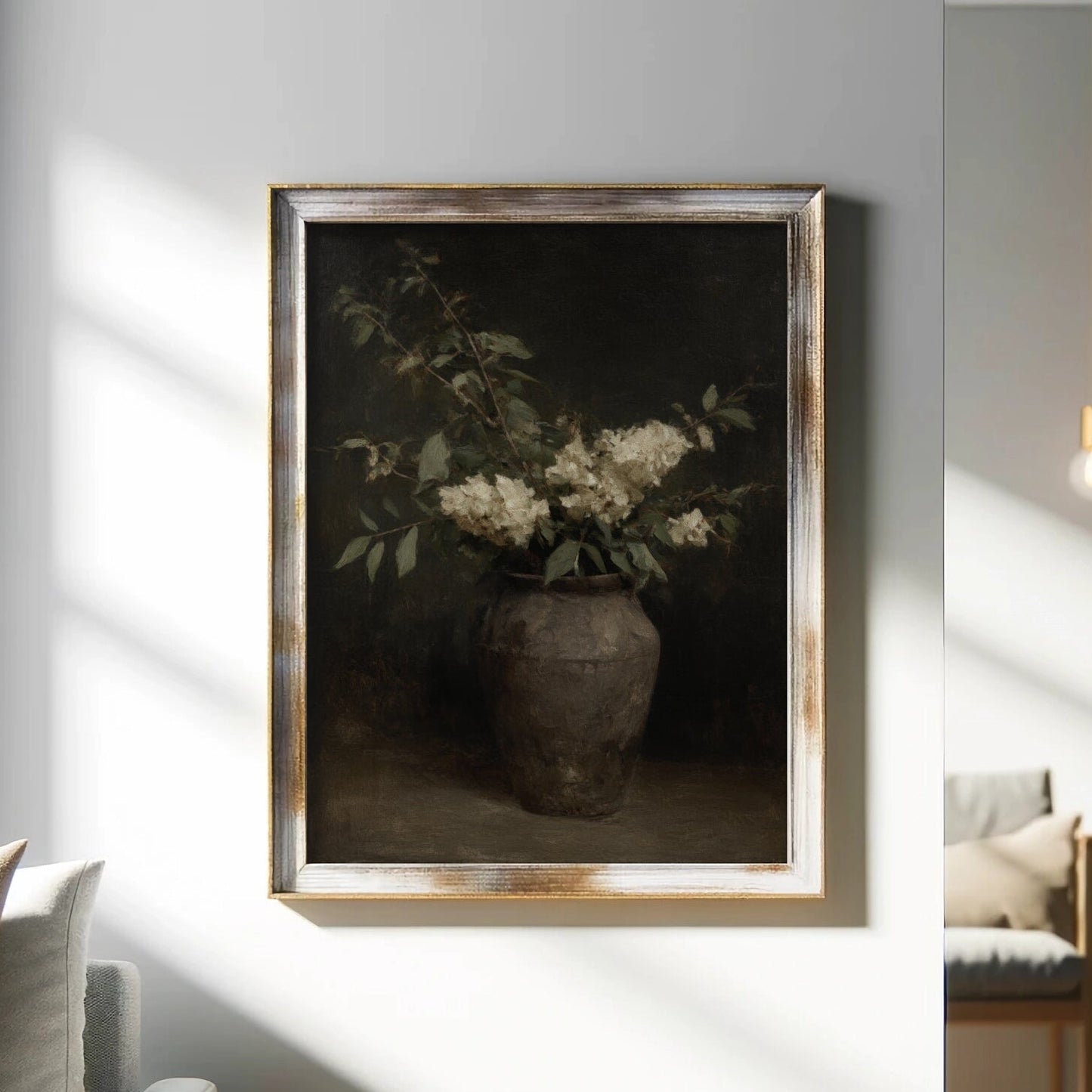 Framed artwork of a vase with flowers on a wall in a living room.