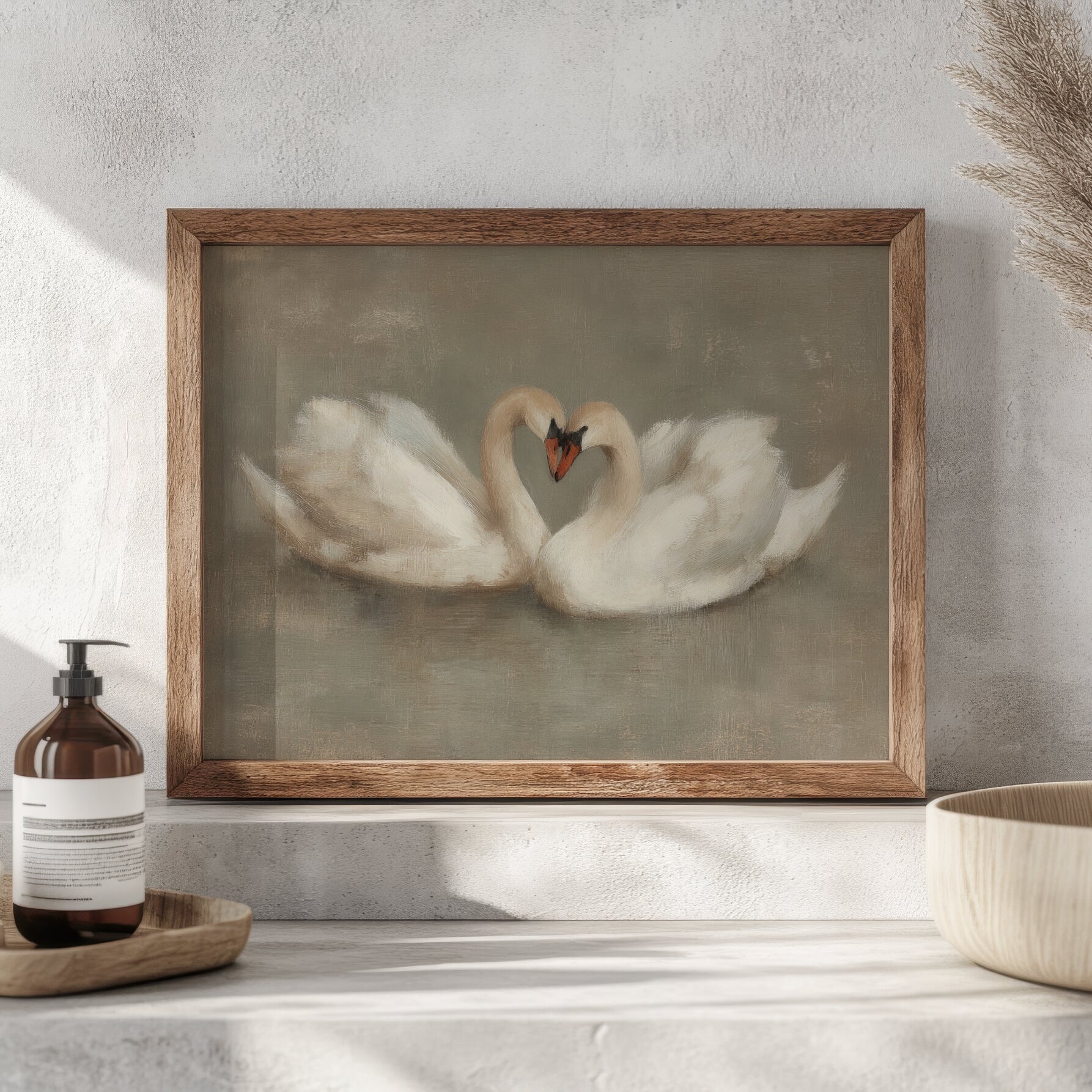 Framed artwork of two swans forming a heart shape on a neutral background.